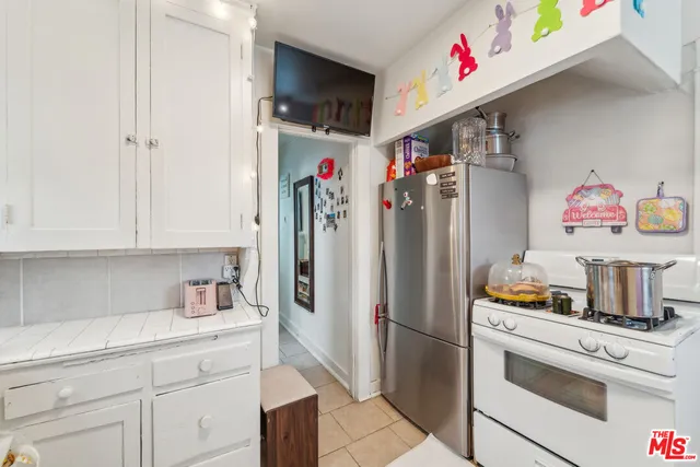 a kitchen with a refrigerator and cabinets