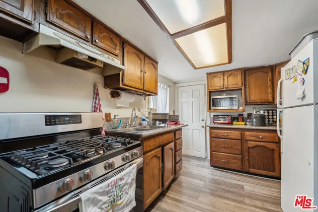 a kitchen with stainless steel appliances granite countertop a stove and a sink