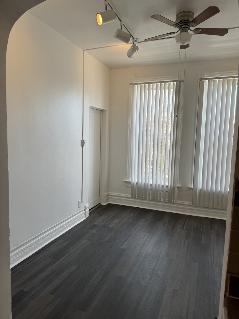 1226 North Artesian Avenue, Unit 2 Chicago, IL 60622 - Photo 2 of 12 an empty room with wooden floor and windows