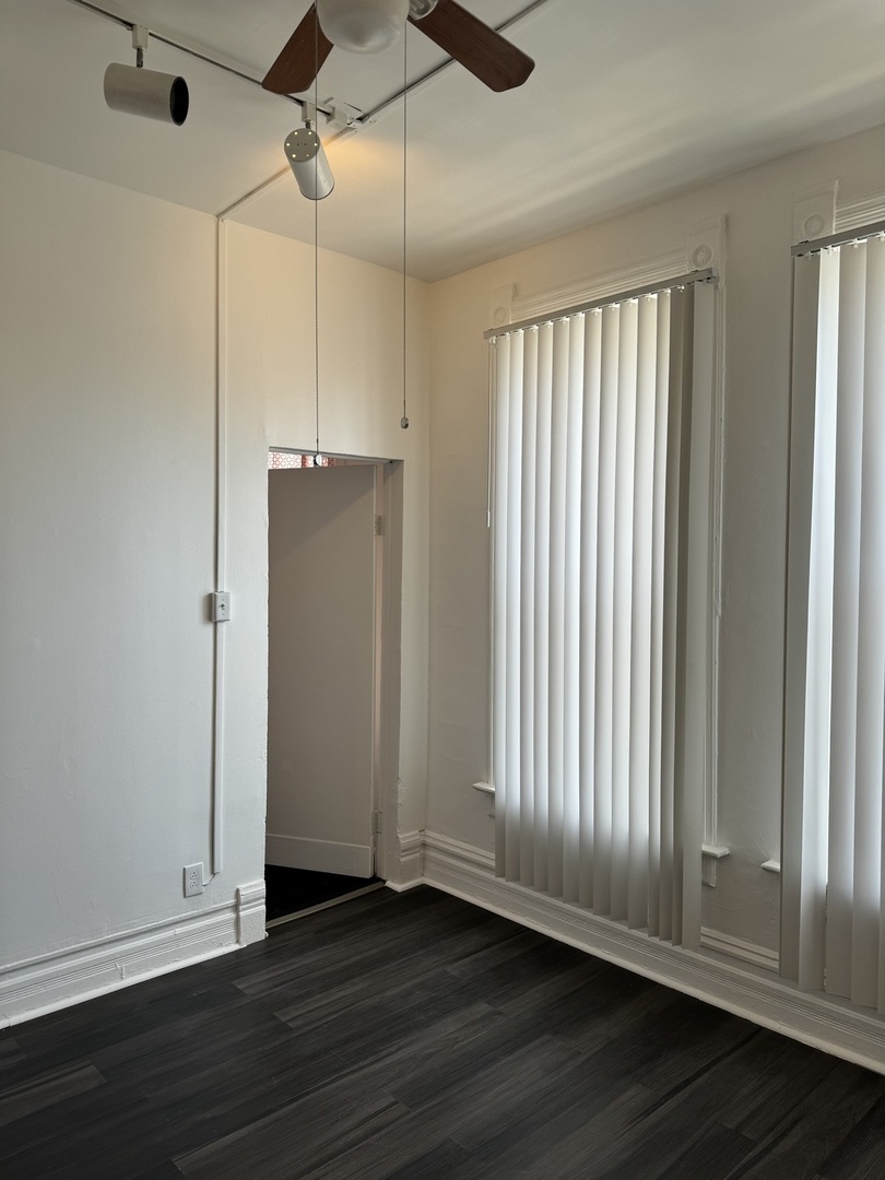 1226 North Artesian Avenue, Unit 2 Chicago, IL 60622 - Photo 5 of 12 an empty room with wooden floor and windows
