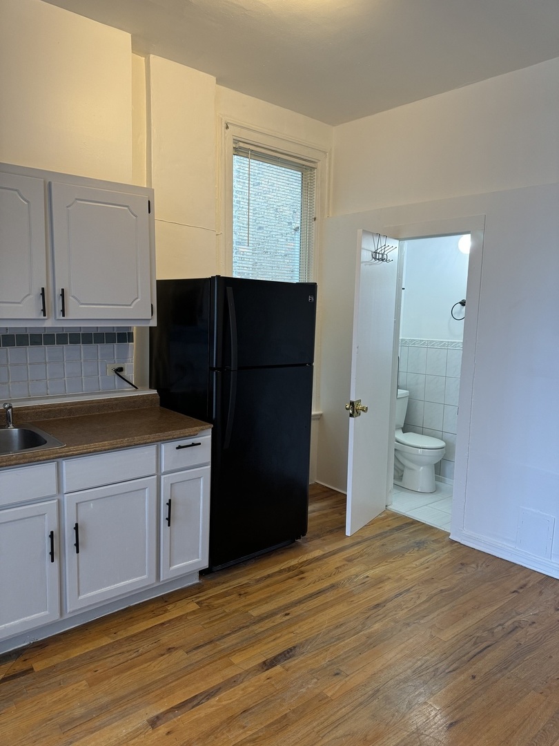 1226 North Artesian Avenue, Unit 2 Chicago, IL 60622 - Photo 6 of 12 a kitchen with a refrigerator and a sink