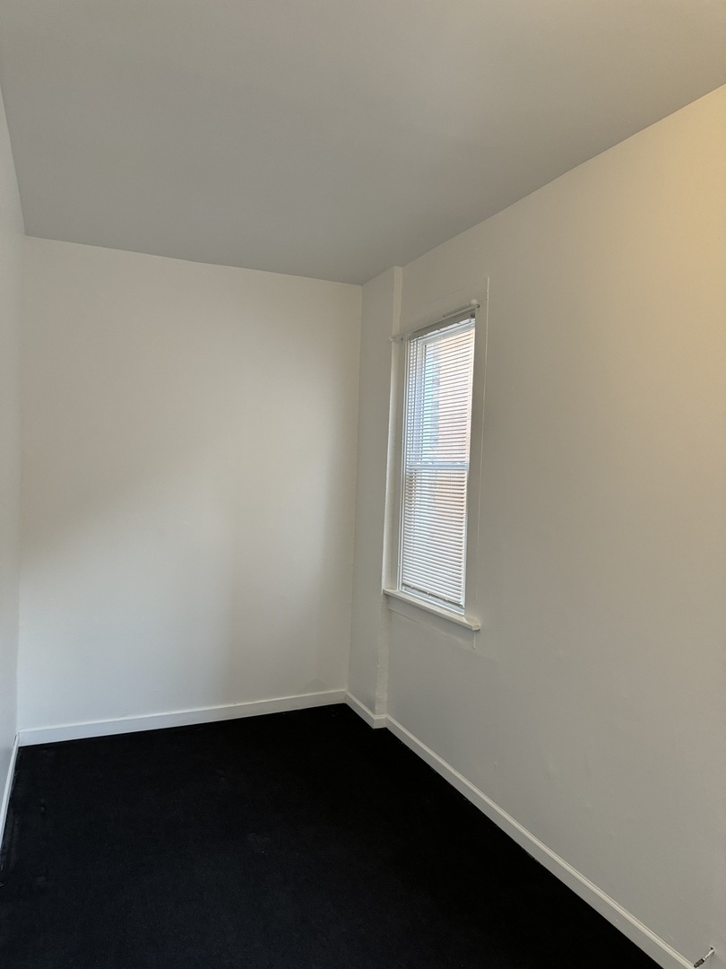 1226 North Artesian Avenue, Unit 2 Chicago, IL 60622 - Photo 9 of 12 an empty room with a window