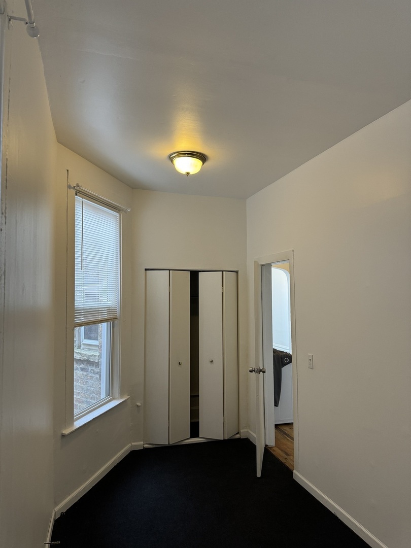 1226 North Artesian Avenue, Unit 2 Chicago, IL 60622 - Photo 10 of 12 an empty room with windows and closet