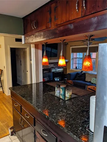 a kitchen area with stainless steel appliances granite countertop a sink and a wooden cabinets