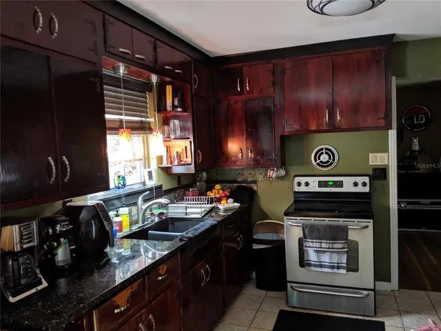 a kitchen with a stove and a refrigerator