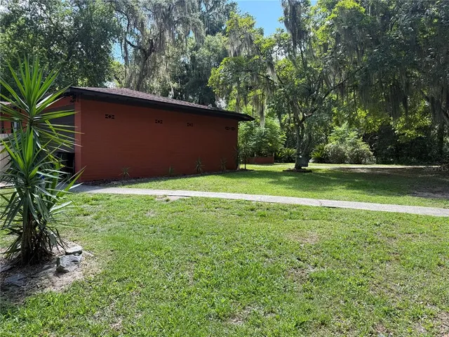 a view of a backyard with large trees