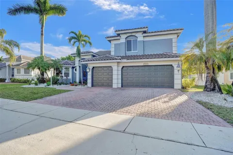 a front view of a house with a yard and a garage