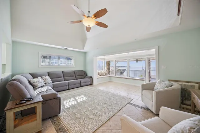 a living room with furniture ceiling fan and a rug