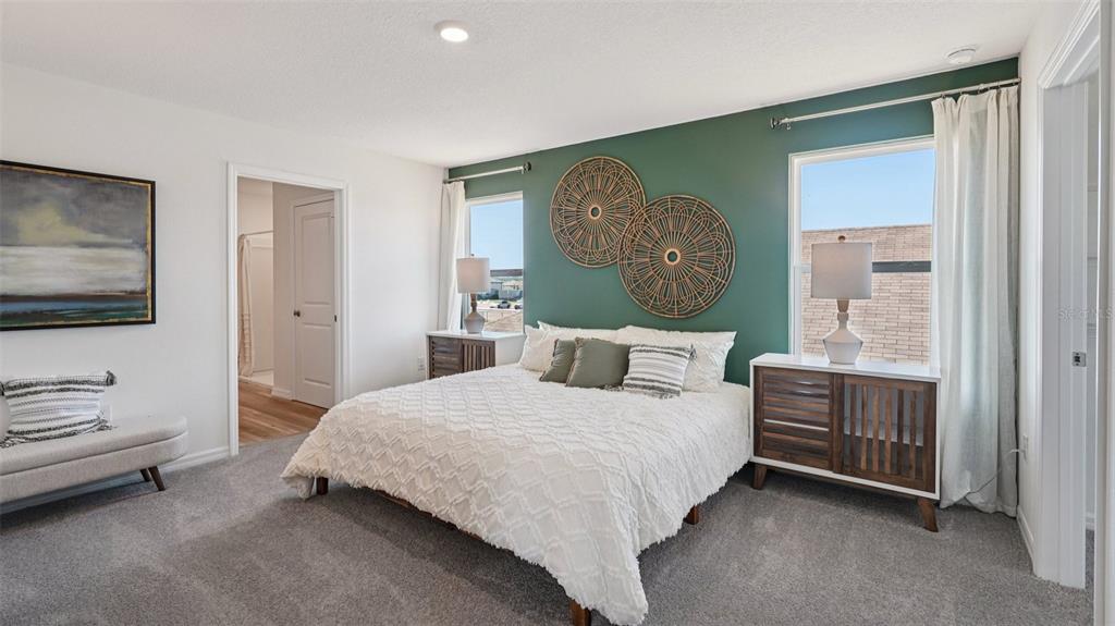 3066 Northeast 21st Ct Road Ocala, FL 34479 - Photo 14 of 27 a bedroom with a bed and a chandelier