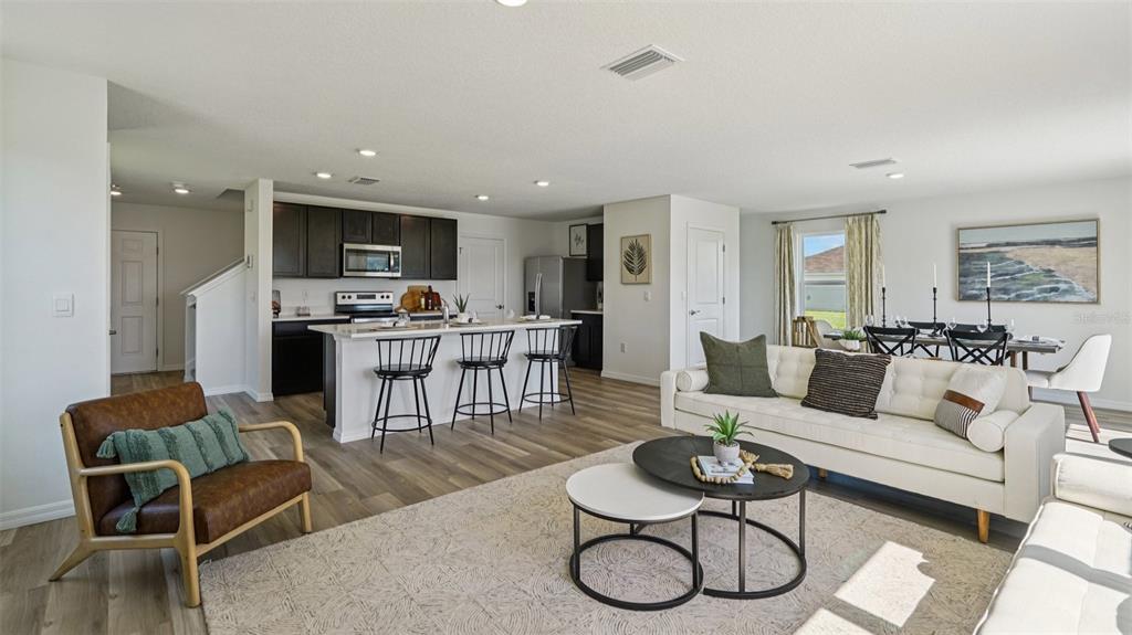 3066 Northeast 21st Ct Road Ocala, FL 34479 - Photo 9 of 27 a living room with furniture a rug kitchen view and a window