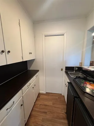 a kitchen with granite countertop a sink and a stove top oven