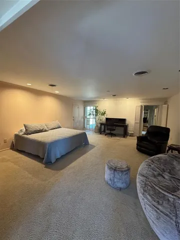 a spacious bedroom with a bed and a couch