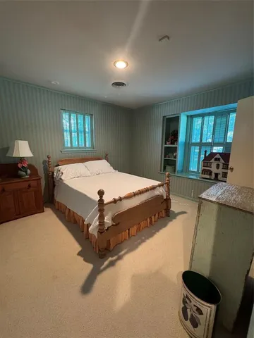 a bed sitting in a room next to a window