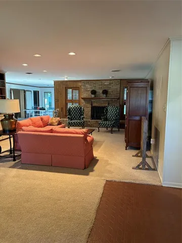 a living room with furniture a flat screen tv and a table