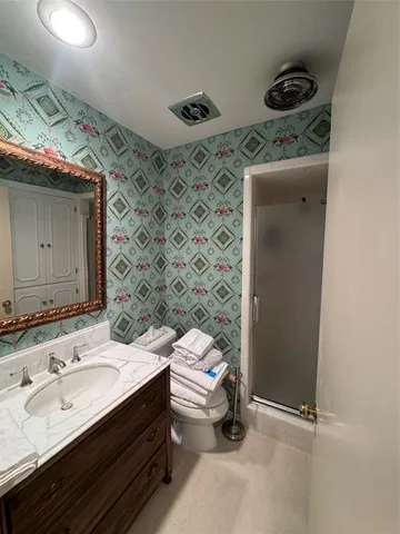 a bathroom with a sink toilet and shower