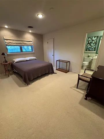 a bedroom with a bed a desk and chair