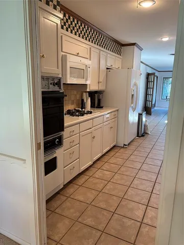 a kitchen with stainless steel appliances a refrigerator sink and cabinets