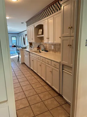 a kitchen with white cabinets and white appliances