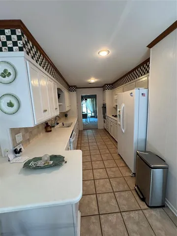a kitchen with a stove and a refrigerator