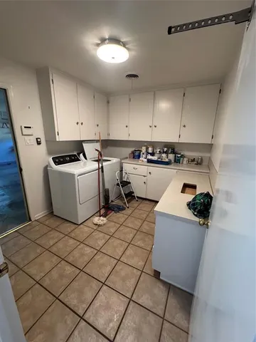 a kitchen with a sink a stove top oven and cabinets