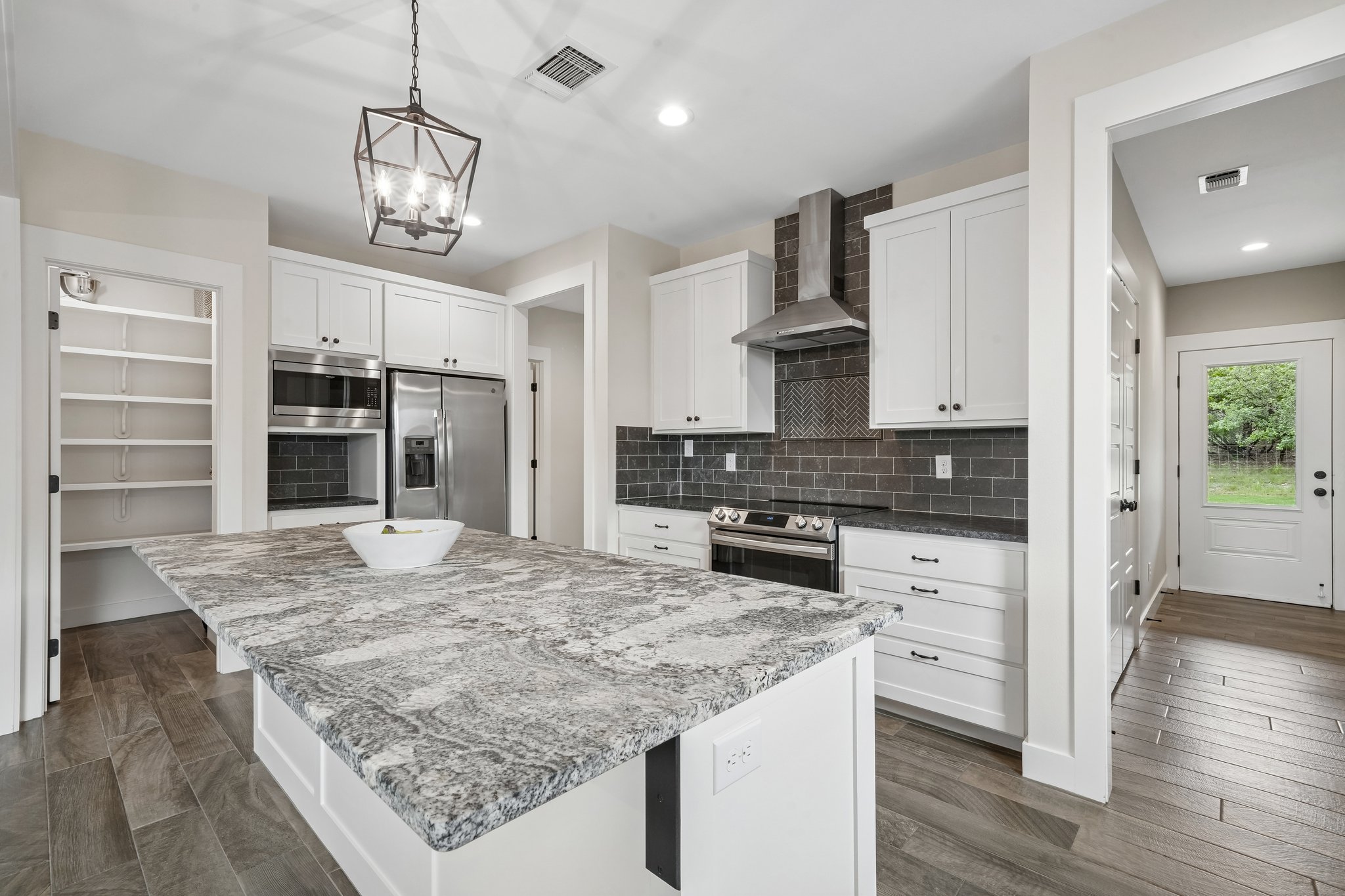 190 Magnolia Meadow Spring Branch, TX 78070 - Photo 6 of 29 A well-appointed kitchen showcasing a spacious island with granite counters, perfect for culinary endeavors.