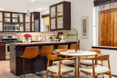 a view of a dining room with furniture and window