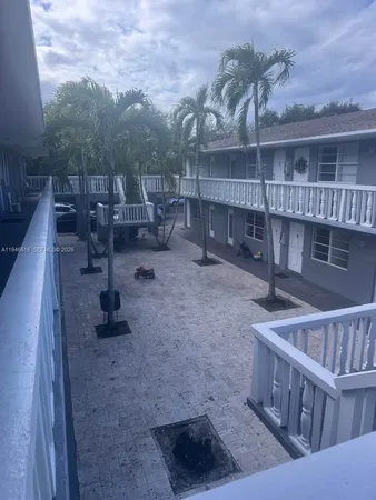 a view of roof deck with table and chairs