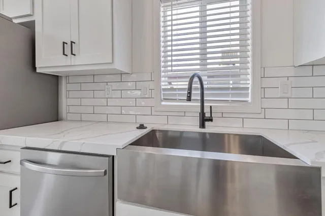a kitchen with granite countertop a sink and a window
