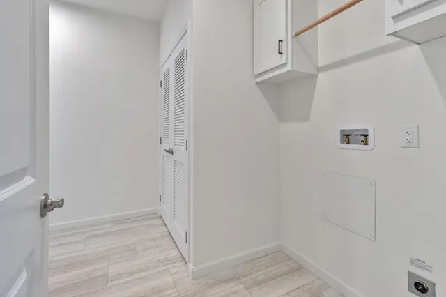 a view of a room with wooden floor