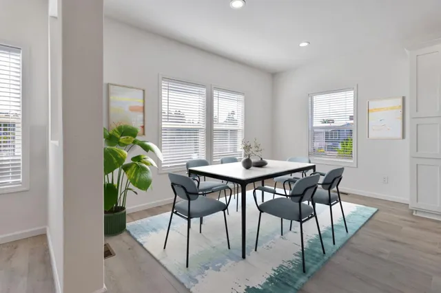 a view of a dining room with furniture and window