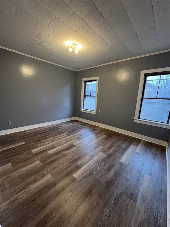 181 Division Street Fall River, MA 02721 - Photo 5 of 14 an empty room with wooden floor and windows