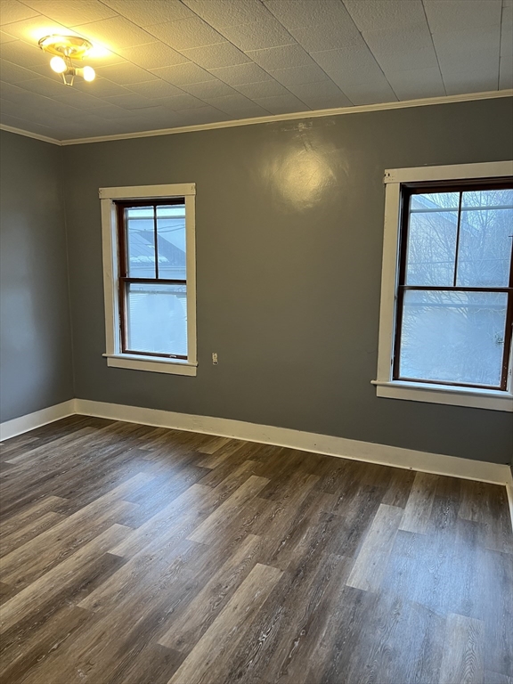 181 Division Street Fall River, MA 02721 - Photo 7 of 14 an empty room with wooden floor and windows