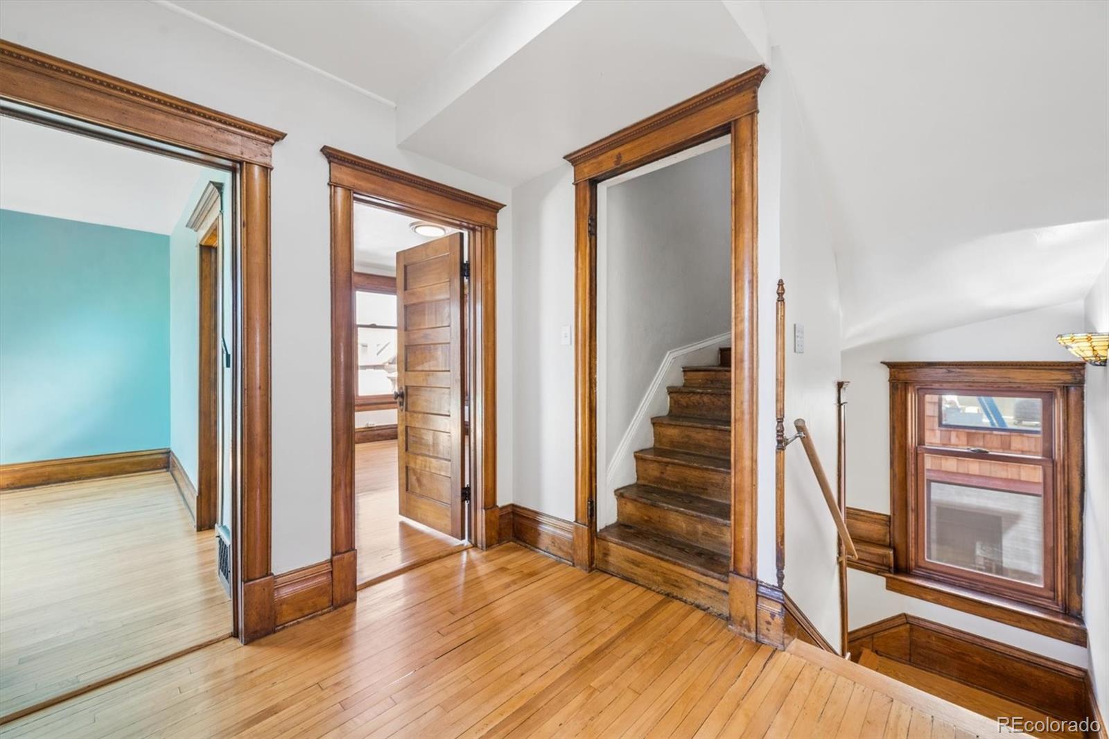 3828 Tejon Street Denver, CO 80211 - Photo 11 of 36 a view of a hallway with wooden floor and staircase