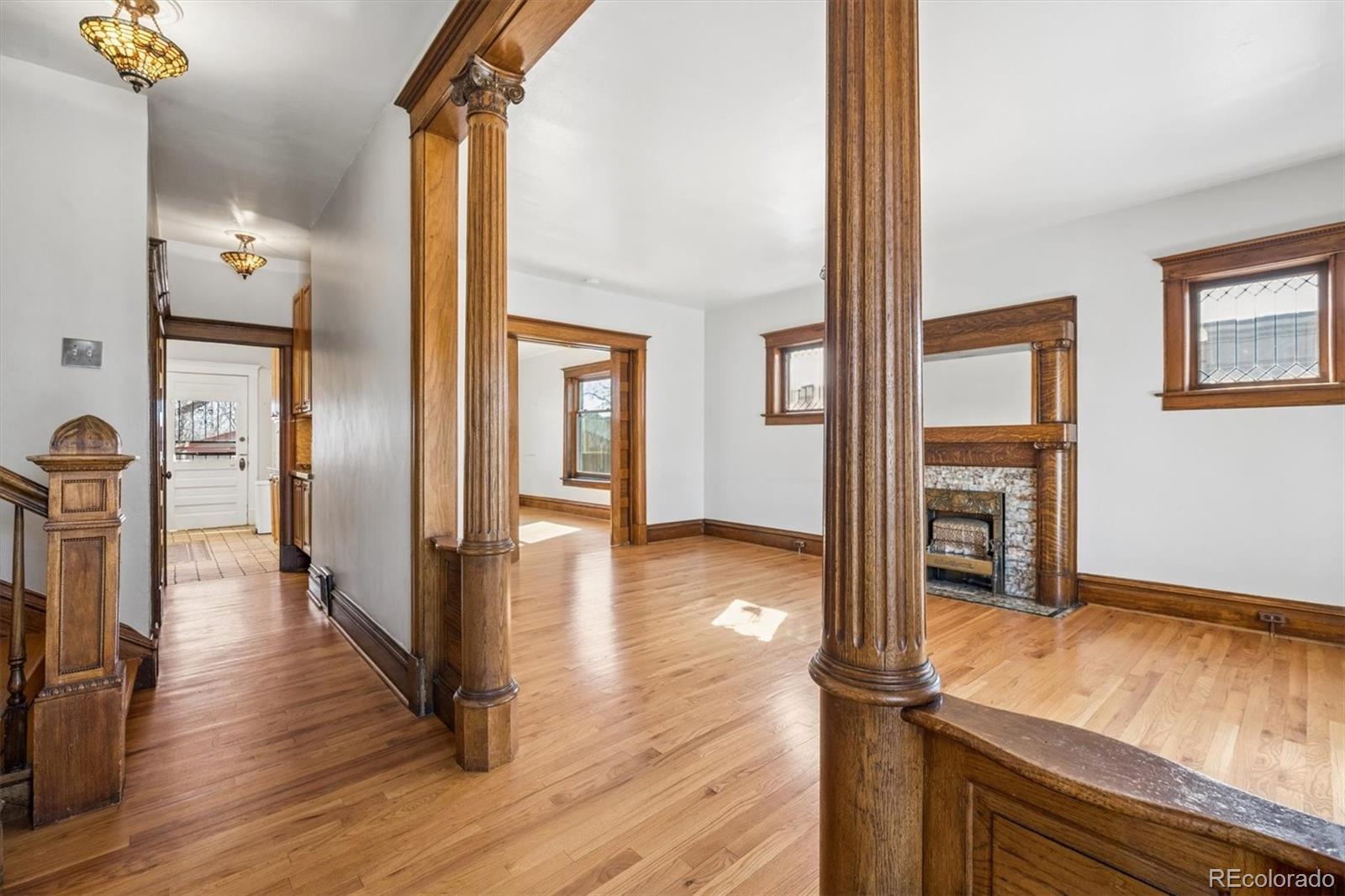 3828 Tejon Street Denver, CO 80211 - Photo 13 of 36 a view of a hallway with wooden floor and staircase