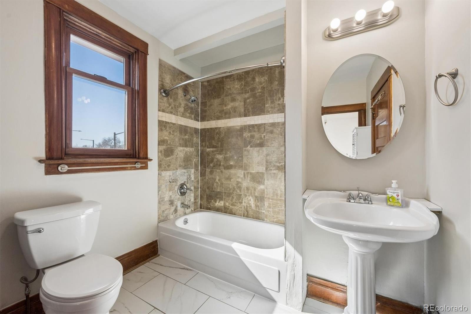 3828 Tejon Street Denver, CO 80211 - Photo 18 of 36 a bathroom with a sink toilet and shower