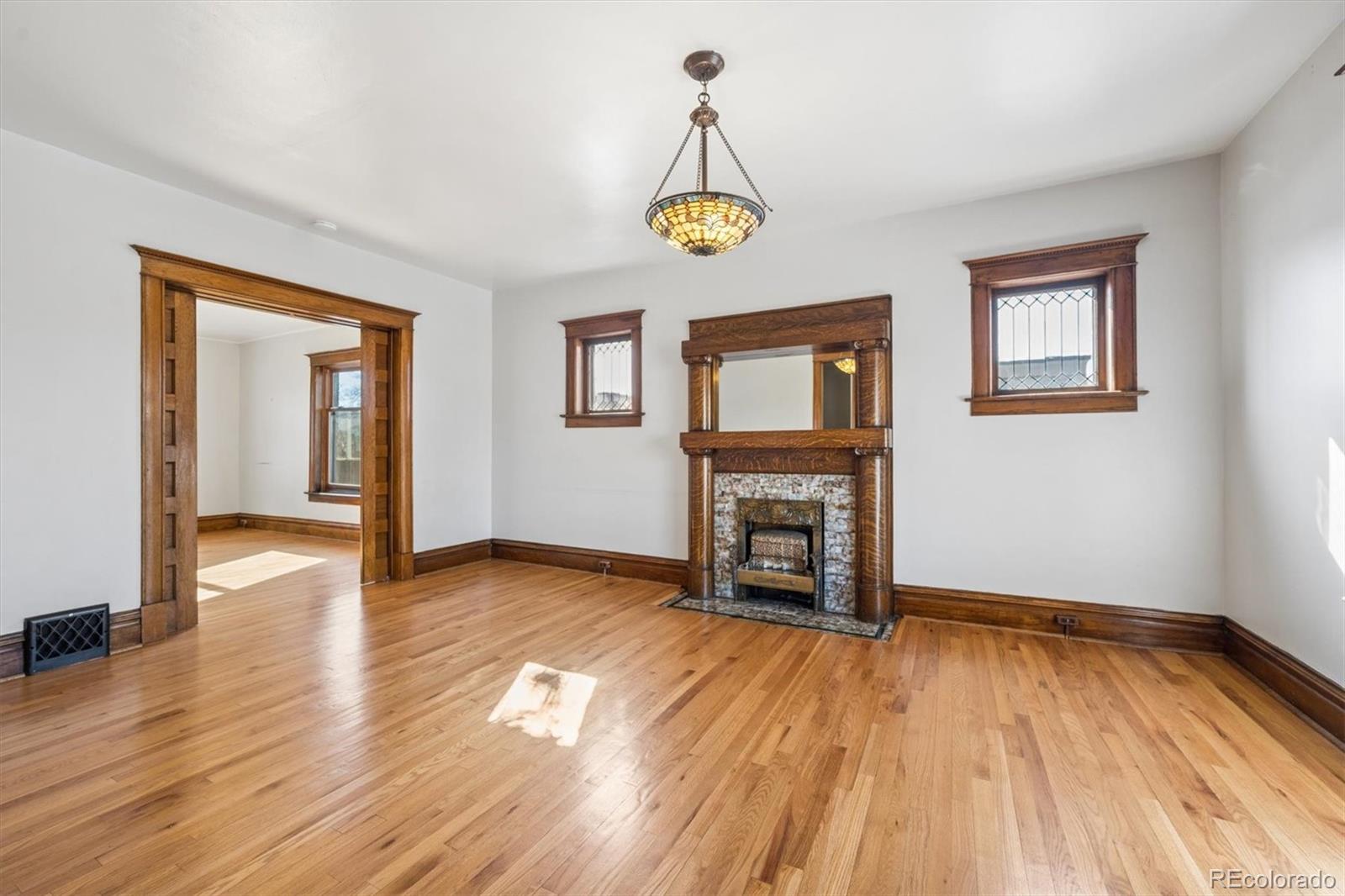 3828 Tejon Street Denver, CO 80211 - Photo 25 of 36 a view of empty room with wooden floor and fireplace