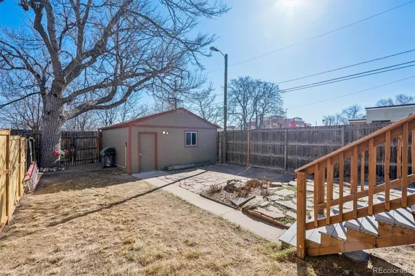 a wooden bench sitting in front of a house