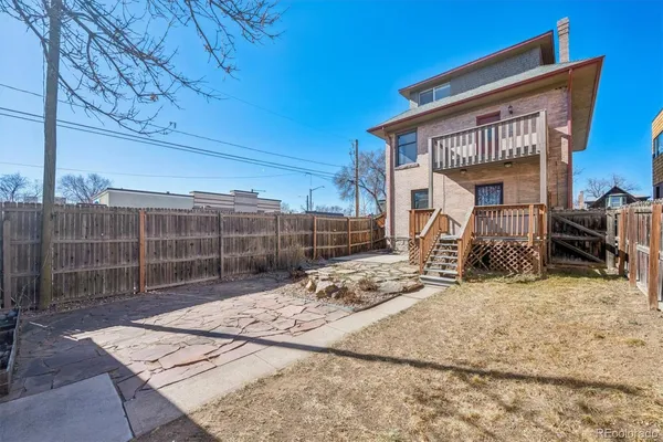 a view of backyard with barbeque grill and outdoor seating