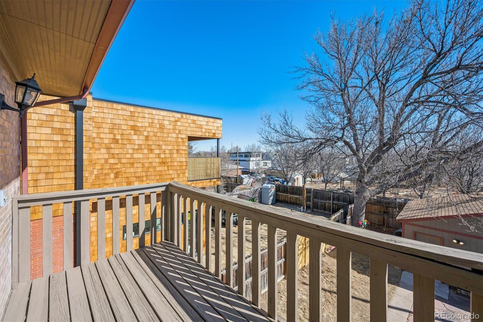 3828 Tejon Street Denver, CO 80211 - Photo 29 of 36 a view of a balcony with wooden floor and fence