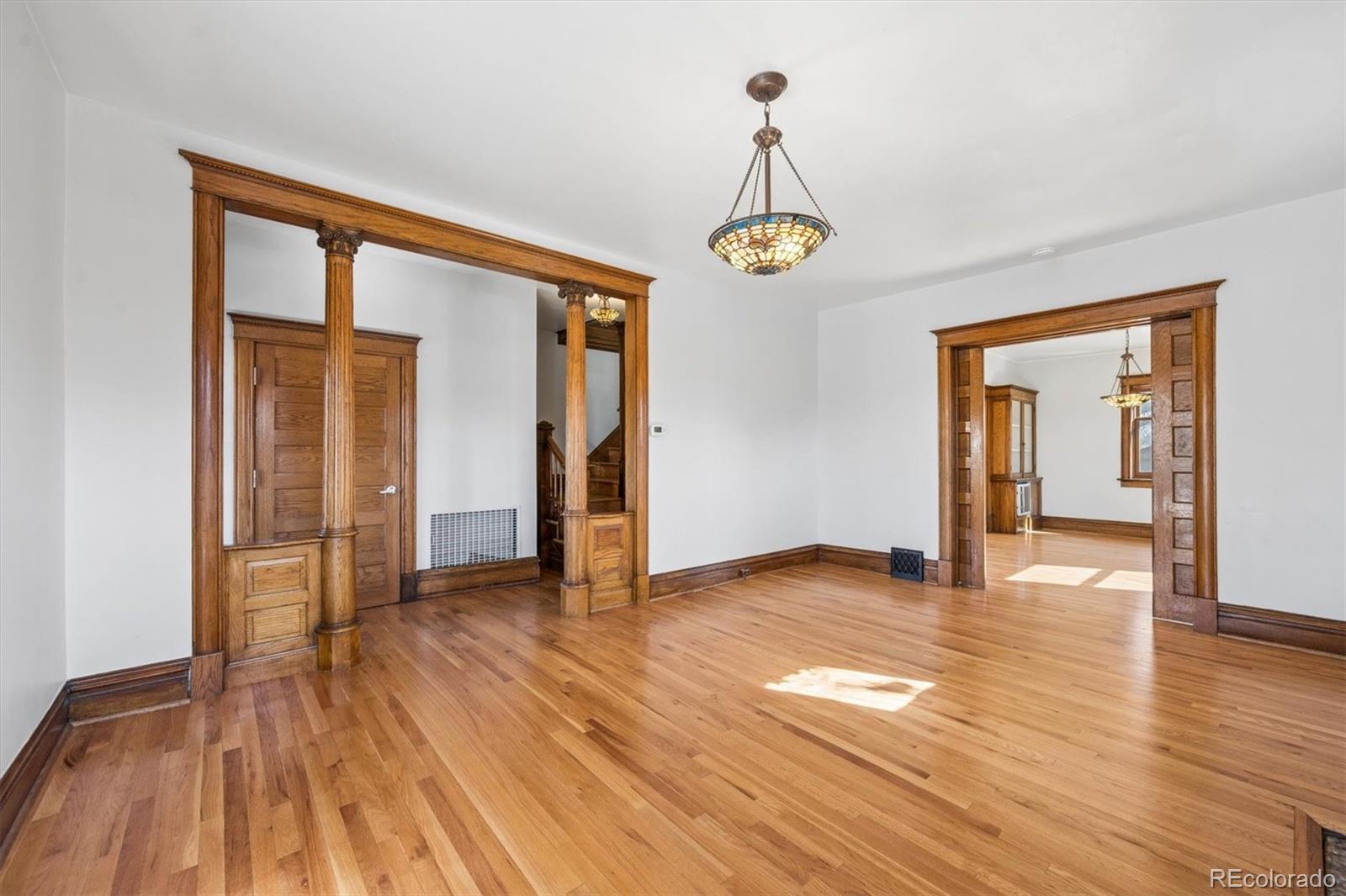 3828 Tejon Street Denver, CO 80211 - Photo 3 of 36 a view of empty room with wooden floor and window