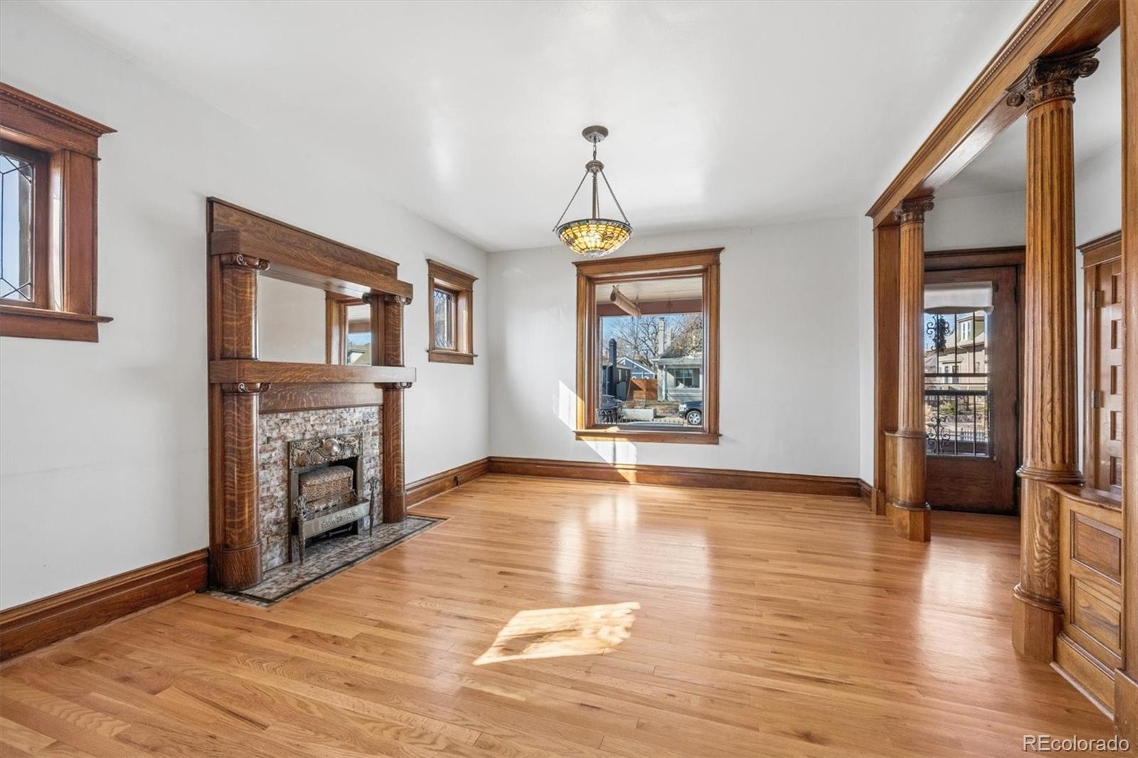 3828 Tejon Street Denver, CO 80211 - Photo 4 of 36 a view of an empty room with window and wooden floor