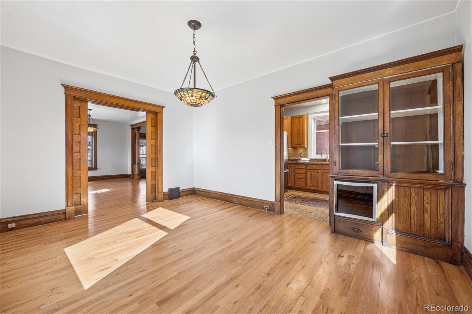 3828 Tejon Street Denver, CO 80211 - Photo 6 of 36 a view of an empty room with wooden floor and a window