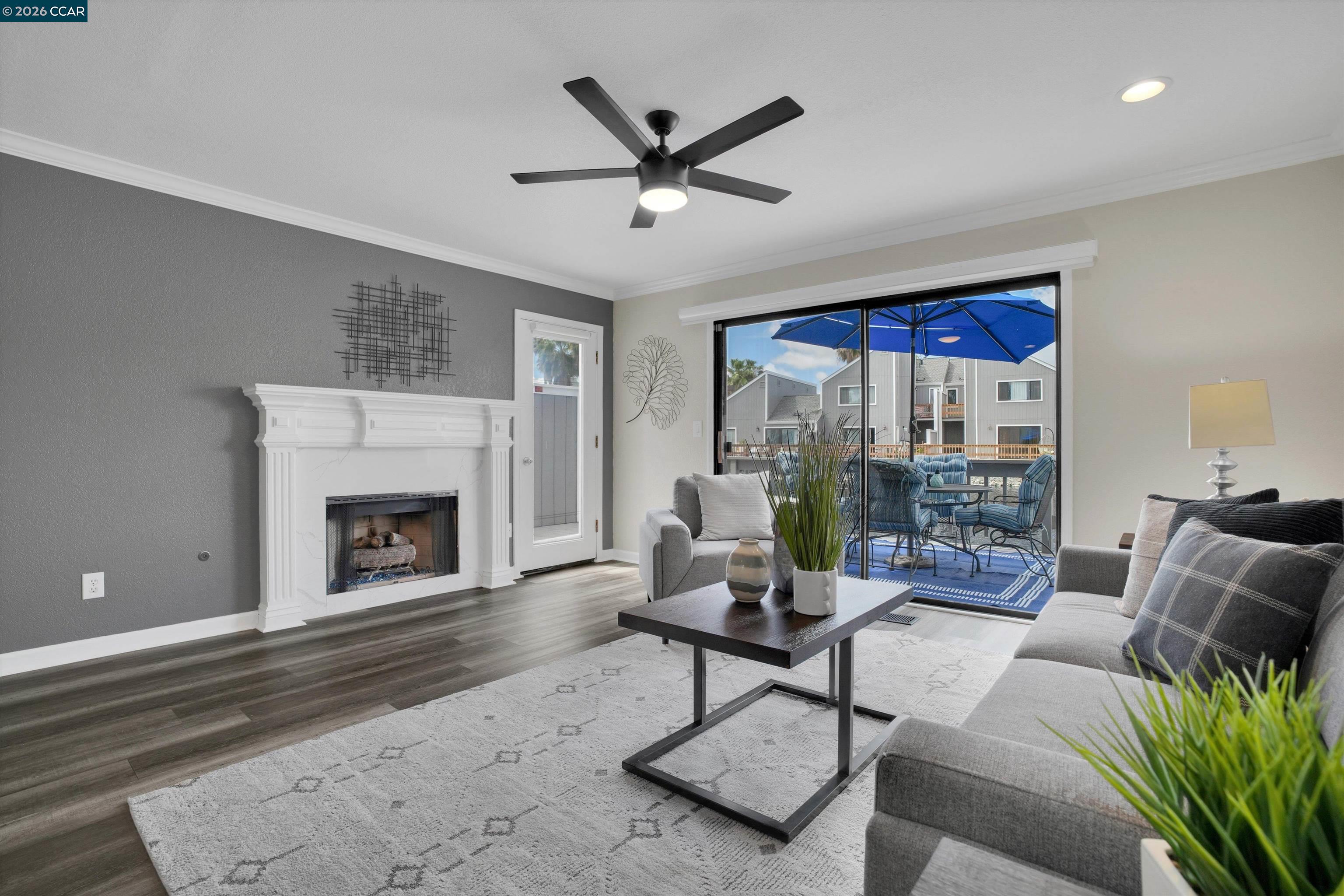 1605 Riverlake Road Discovery Bay, CA 94505 - Photo 16 of 39 a living room with furniture a fireplace and a floor to ceiling window
