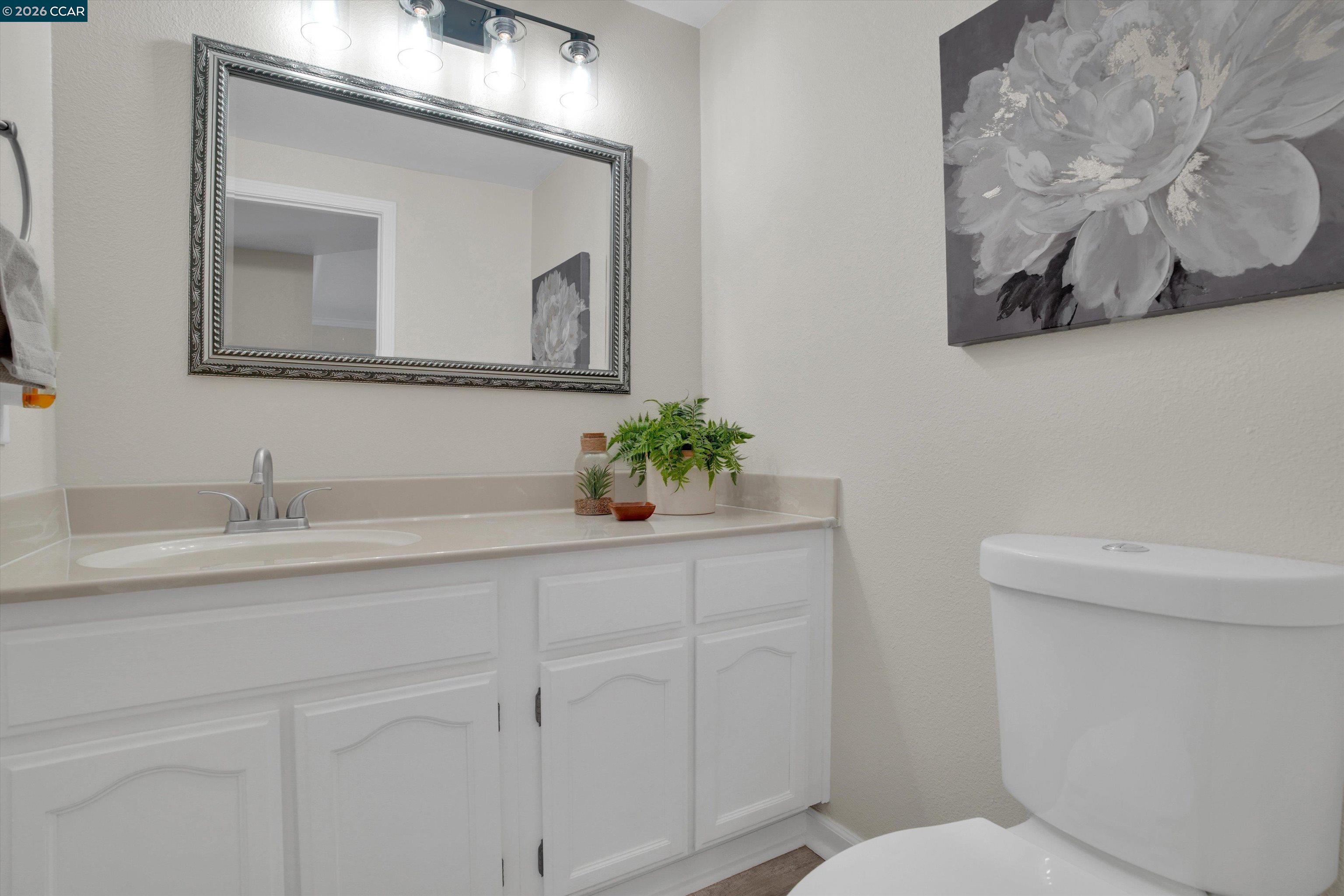 1605 Riverlake Road Discovery Bay, CA 94505 - Photo 18 of 39 a bathroom with a toilet sink and mirror