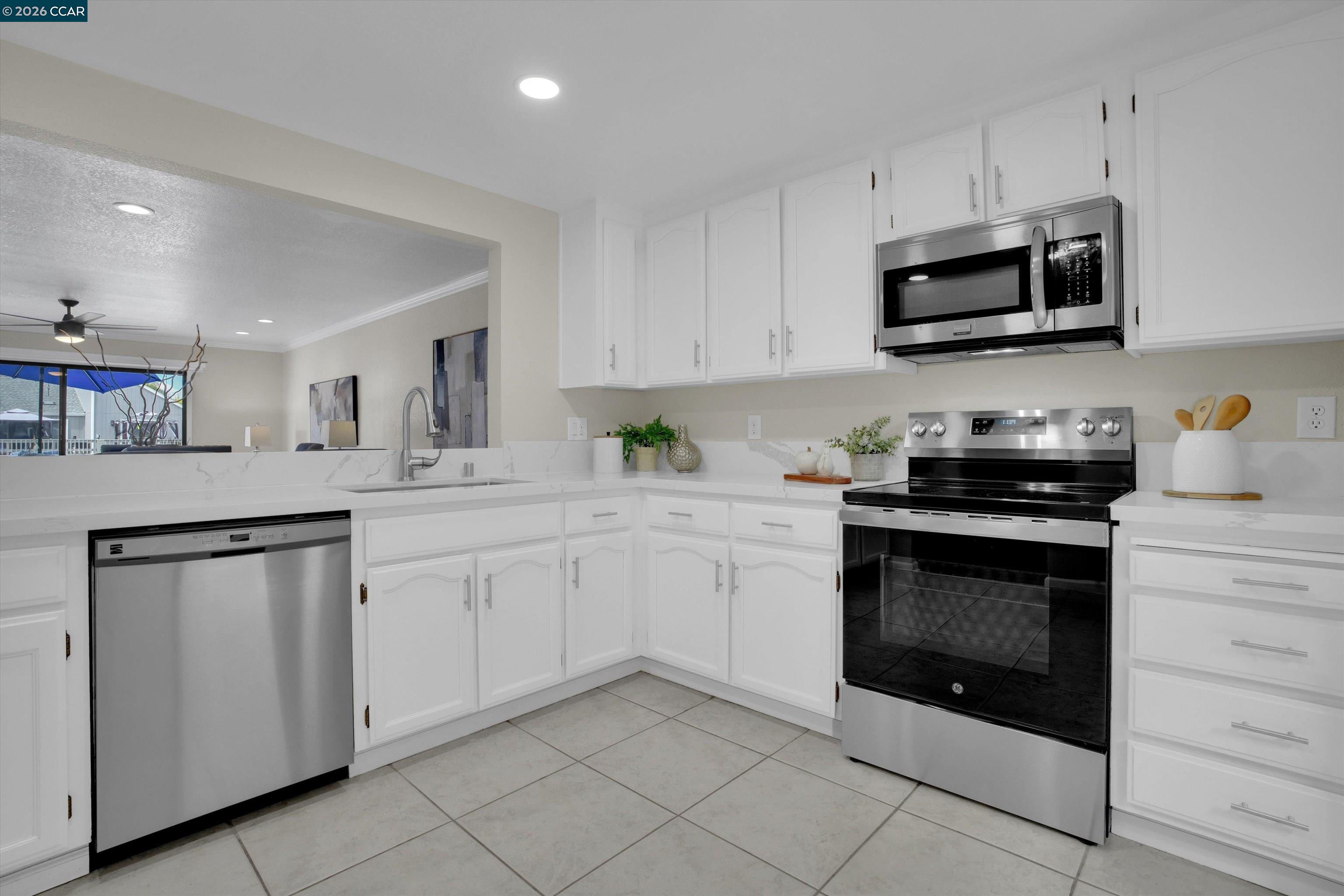 1605 Riverlake Road Discovery Bay, CA 94505 - Photo 9 of 39 a kitchen with white cabinets and stainless steel appliances