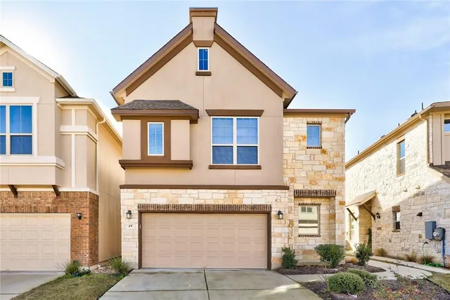 a front view of a house with a garage