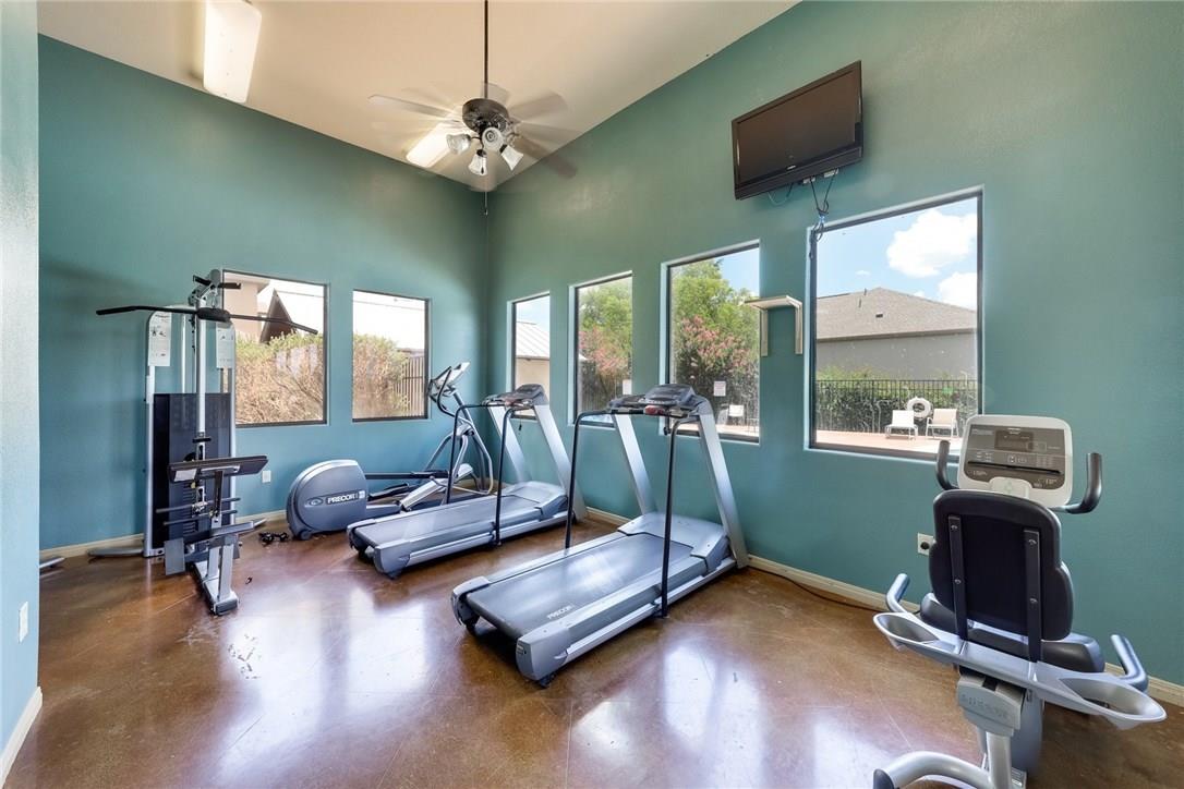 2105 Town Centre Drive, Unit 49 Round Rock, TX 78664 - Photo 21 of 22 a living room with furniture gym equipment and a large window