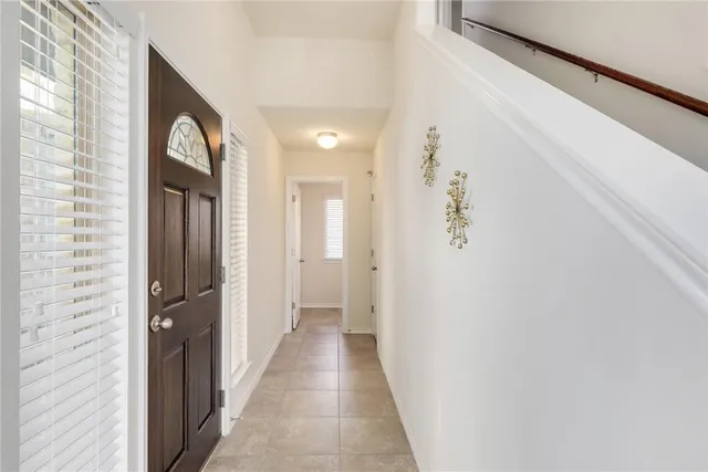 a view of a hallway with wooden floor and glass door