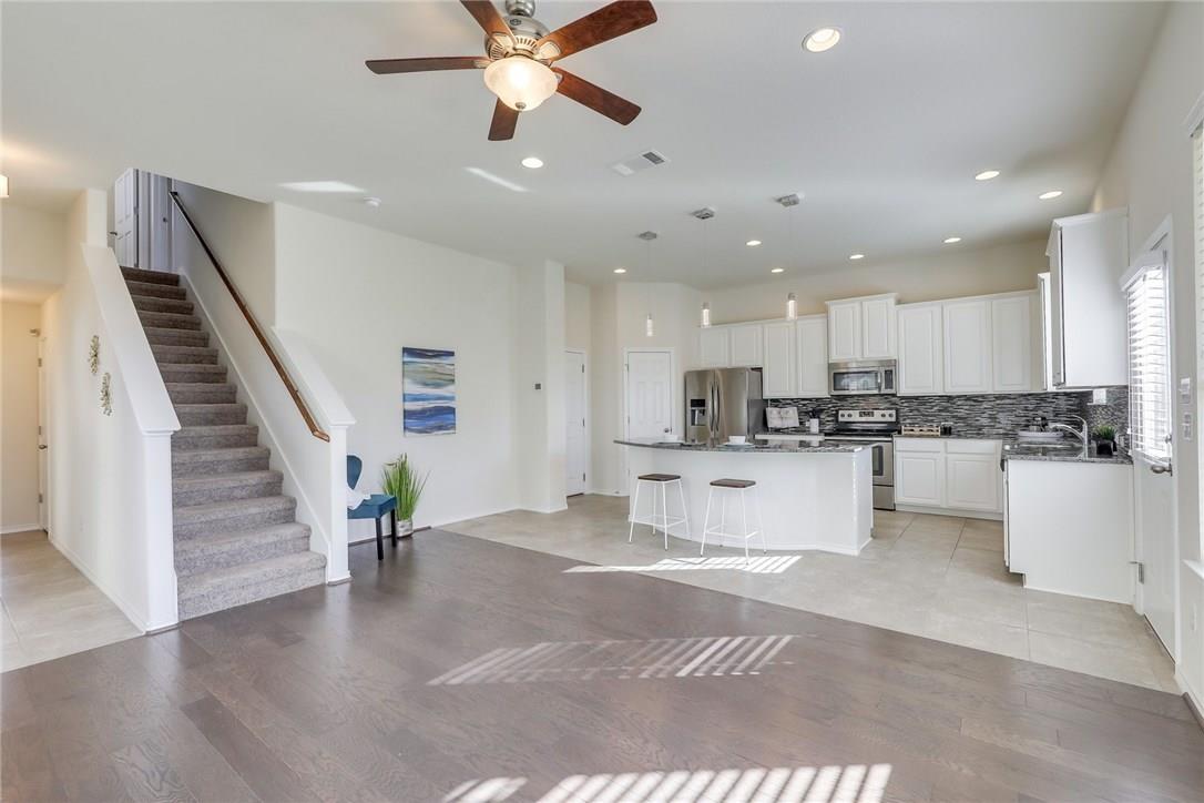 2105 Town Centre Drive, Unit 49 Round Rock, TX 78664 - Photo 6 of 22 a view of kitchen with center island wooden floor and stainless steel appliances