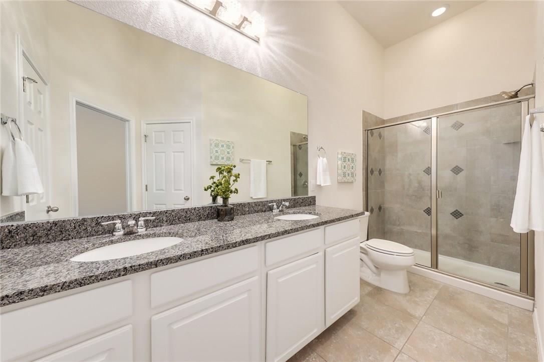 2105 Town Centre Drive, Unit 49 Round Rock, TX 78664 - Photo 9 of 22 a bathroom with a granite countertop sink toilet and shower
